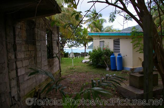 Looking out towards Cane Garden Bay in Tortola from behind two houses.jpg
