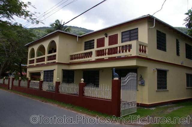 Light yellow house at Cane Garden Bay beach in Tortola.jpg