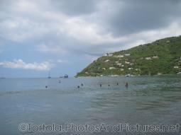 Green hill borders the waters of Cane Garden Bay in Tortola.jpg
