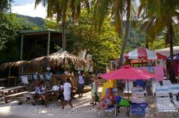 Huts, umbrellas and chairs at beach on Cane Garden Bay in Tortola.jpg