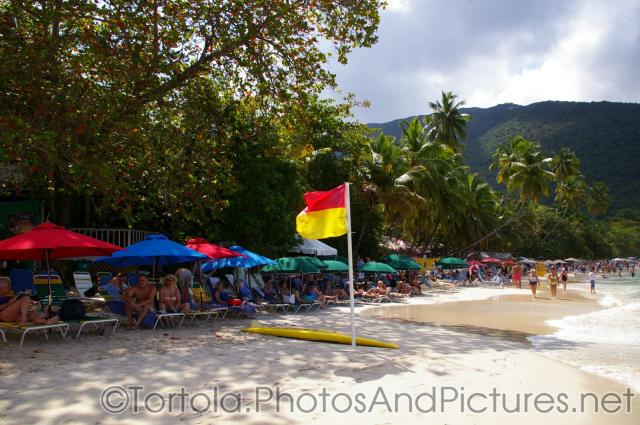 Red and yellow flag planted on beach of Cane Garden Bay in Tortola.jpg
