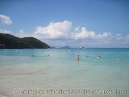 Vacationers wade in the waters of Cane Garden Bay in Tortola.jpg