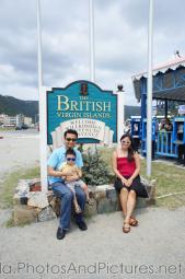 Darwin being held by Daddy sitting next to Mommyn front of Welcome to the British Virgin Islands sign in Tortola .jpg
