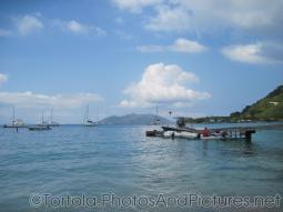 Boats float in front of a pier at Cane Garden Bay in Tortola.jpg
