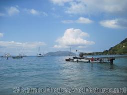 Boats float in front of a pier at Cane Garden Bay in Tortola.jpg