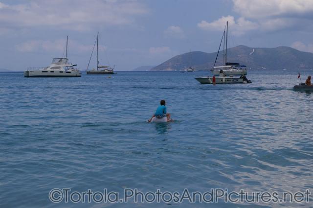 Kid on shoulders of an adult wading in the waters of Cane Garden Bay in Tortola.jpg
